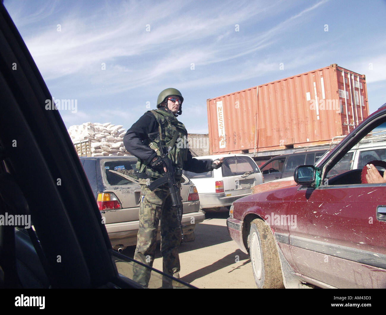 Karbala Iraq Polish soldier directing the traffic Stock Photo