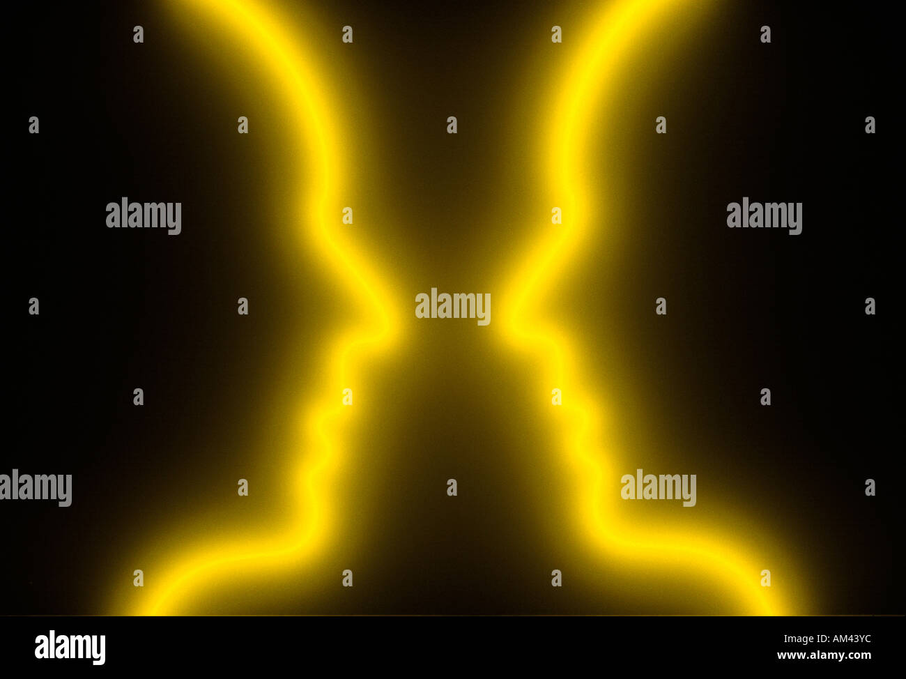 Two glowing yellow outlines of a face Stock Photo
