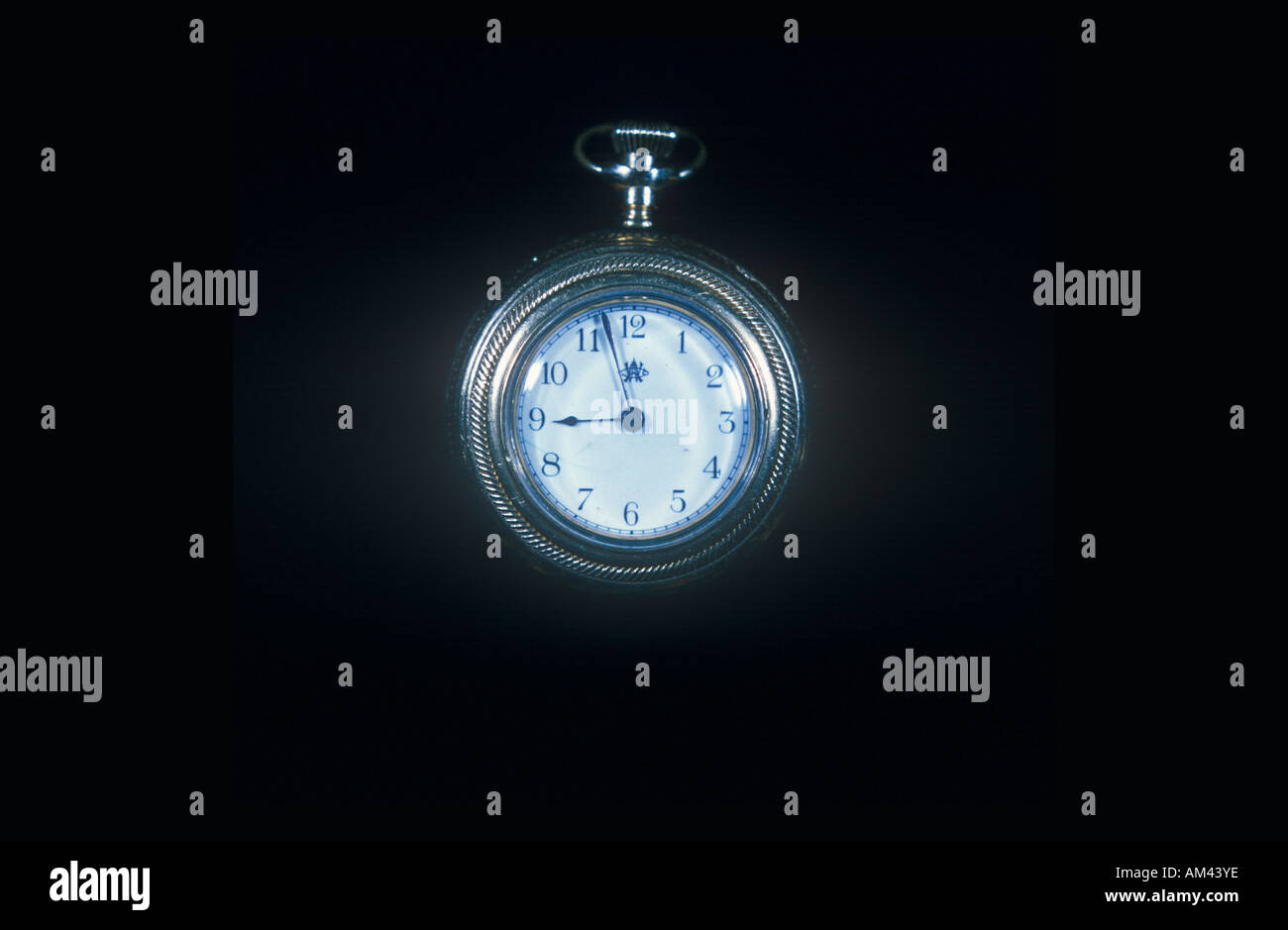A pocketwatch against a black background Stock Photo