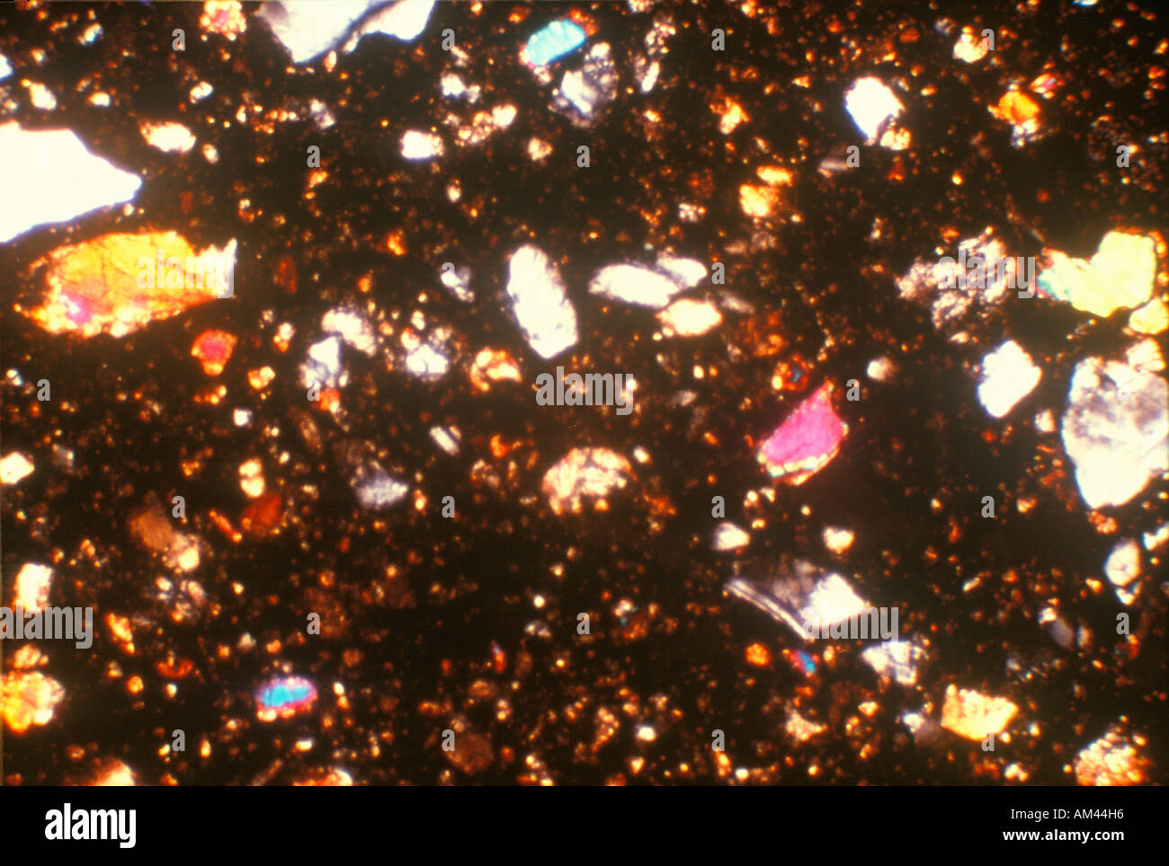 Multicolored glowing crystalline mineral rock formations Stock Photo