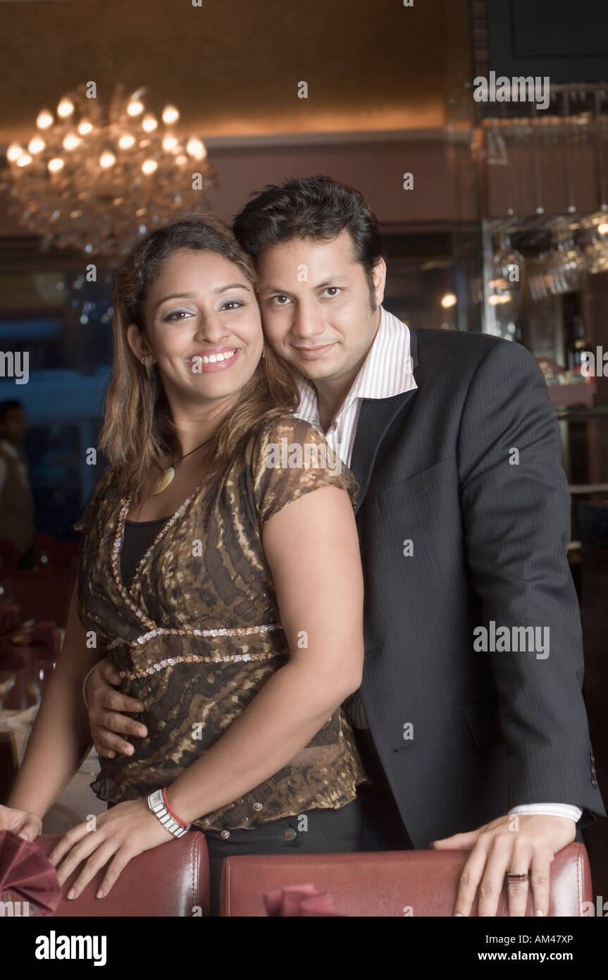 Portrait of a young man embracing a young woman in a restaurant Stock ...