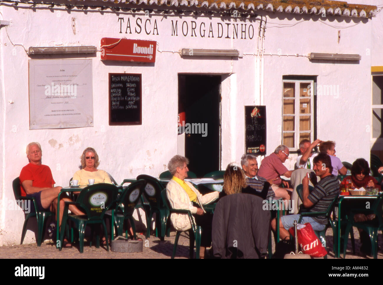 group of tourists outside resturant Alvor jetty Portugal Algarve Stock Photo