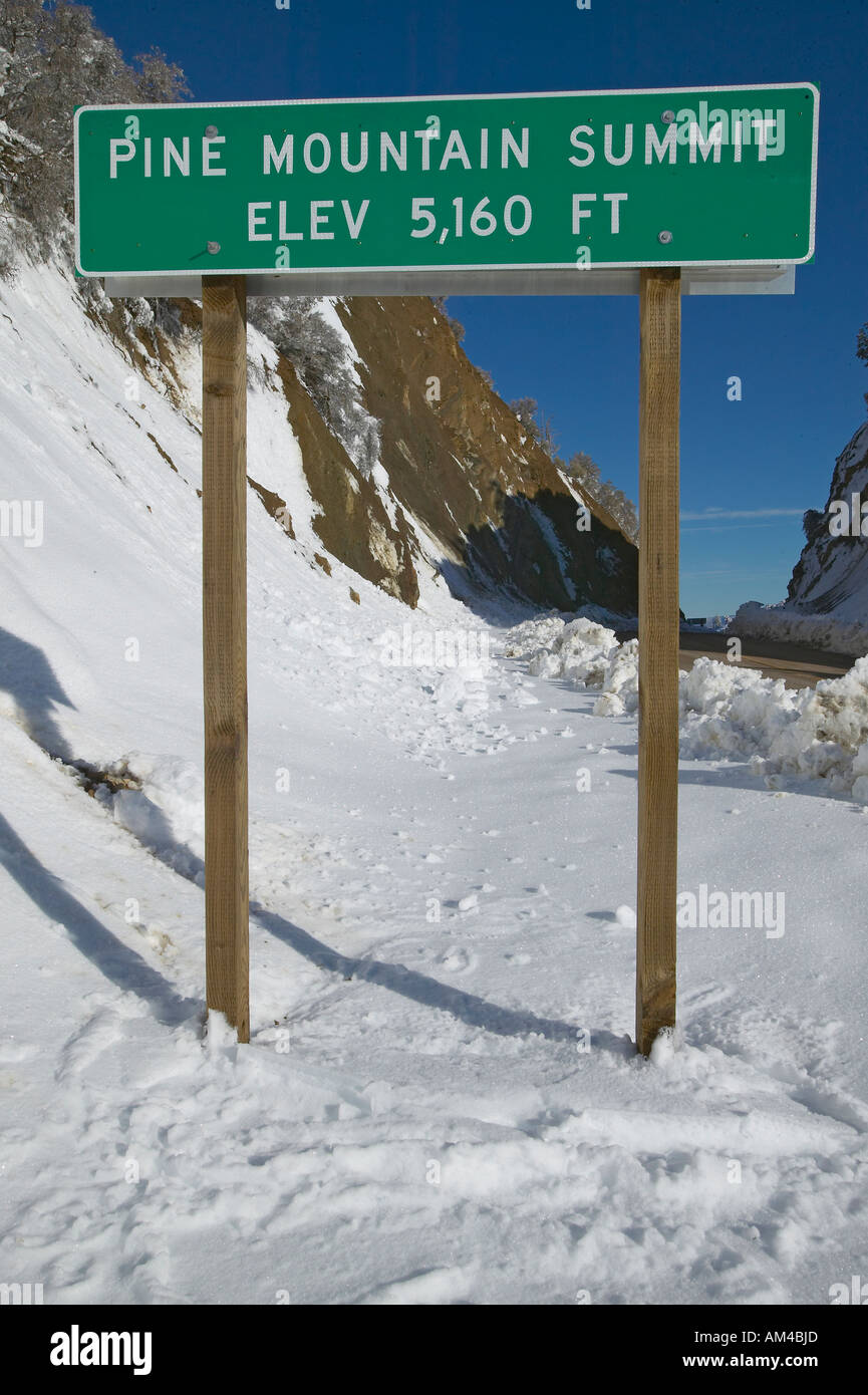 Pine Mountain Summit elevation sign after fresh snowfall along Highway