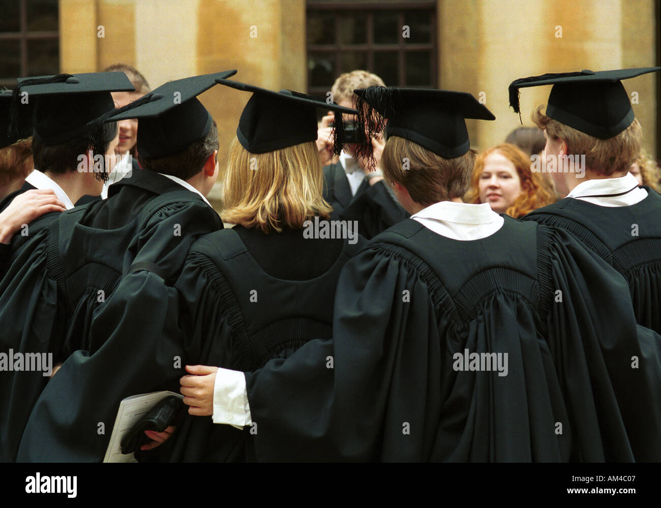Students pose for pictures at Oxford University degree ceremony Stock