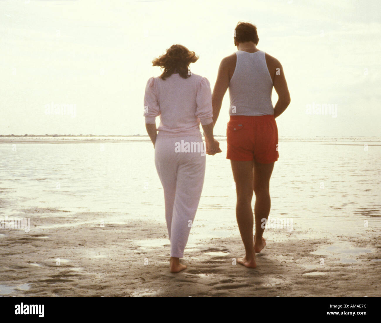 couple walks on the beach Stock Photo