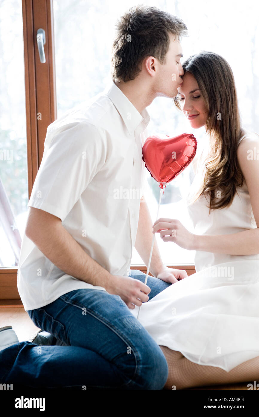 couple with heart-shaped balloon Stock Photo - Alamy
