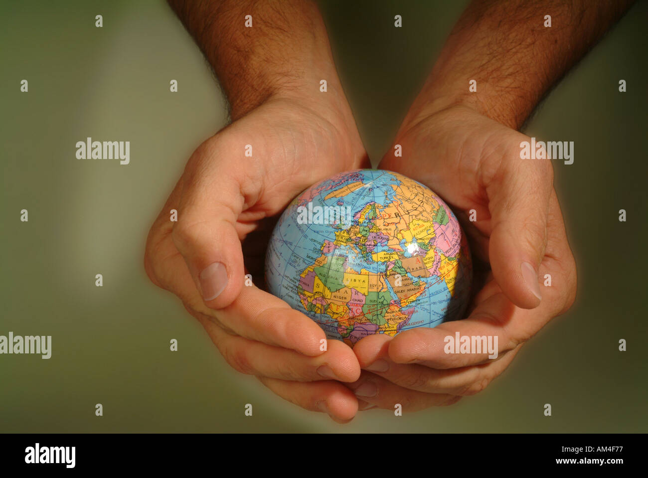 hands cradle a small globe Stock Photo - Alamy