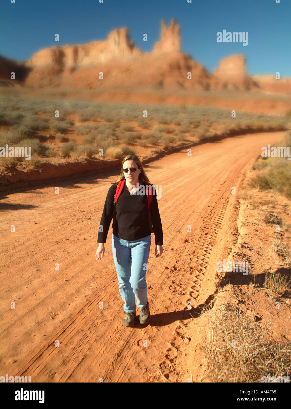 A woman hikes in the desert of the US southwest Stock Photo
