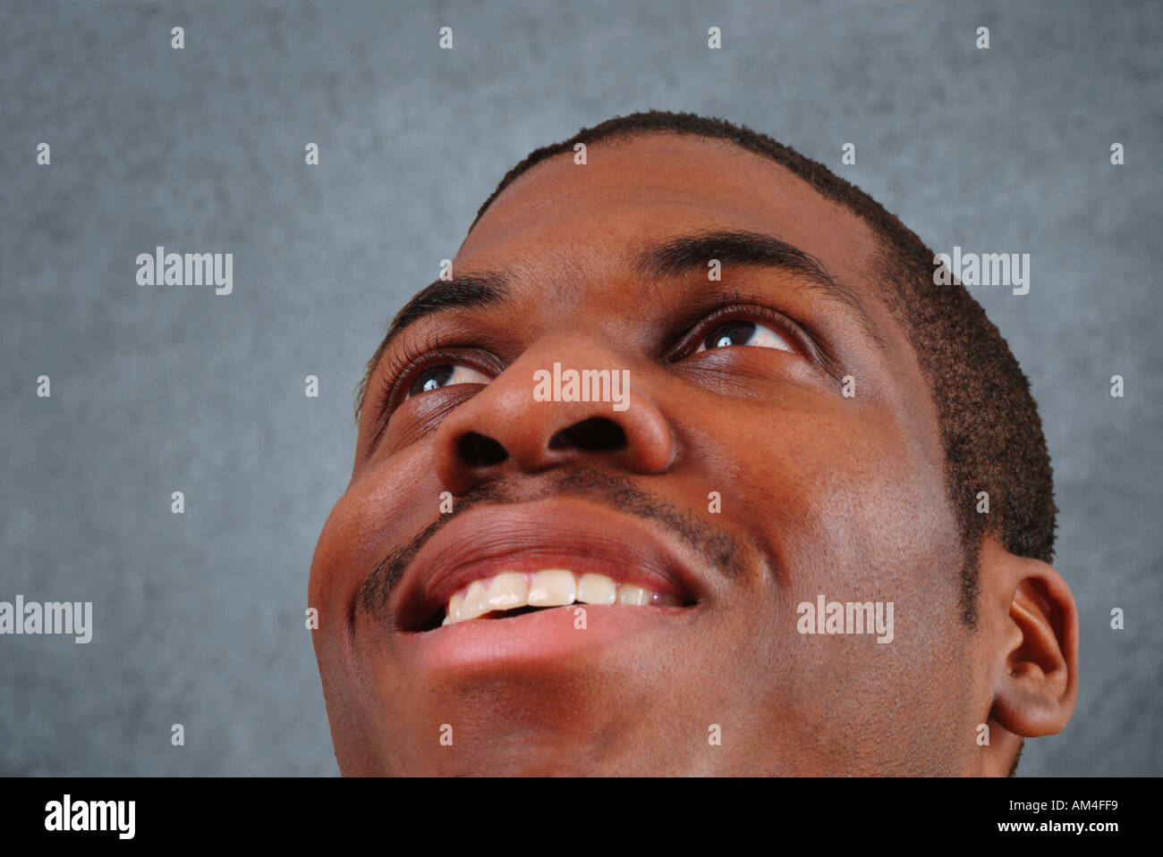 African American man looking up and smiling Stock Photo