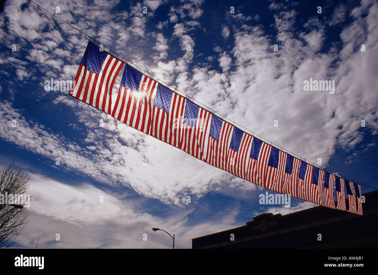 american flag banner backlit hung across main street downtown fourth