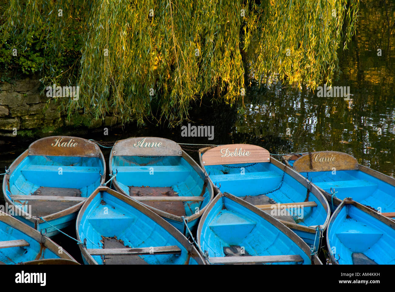 Blue self row rowing boats for hire and moored at Magdalen Bridge on