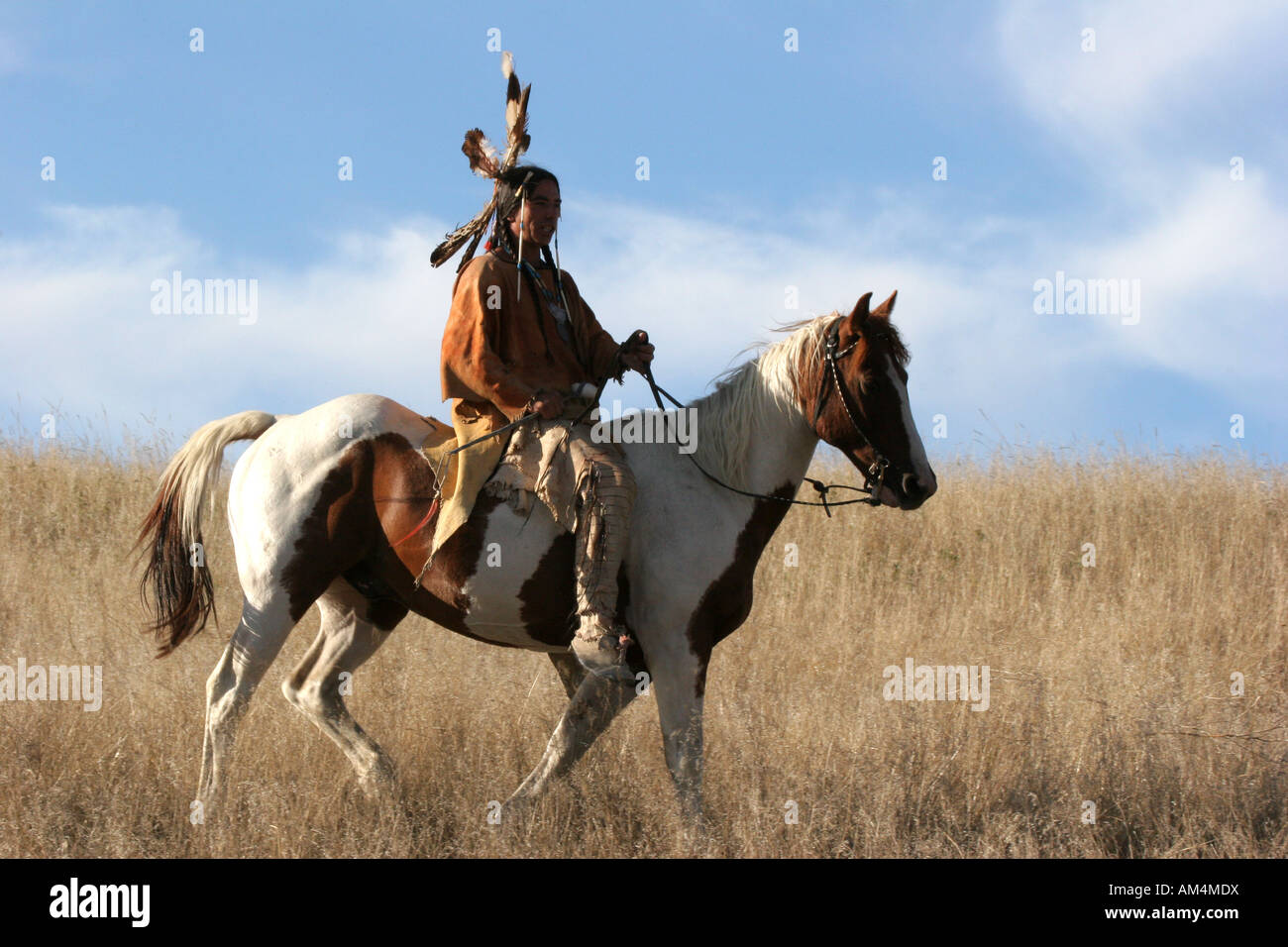 A Native American Indian man on horseback riding the prairie of South ...