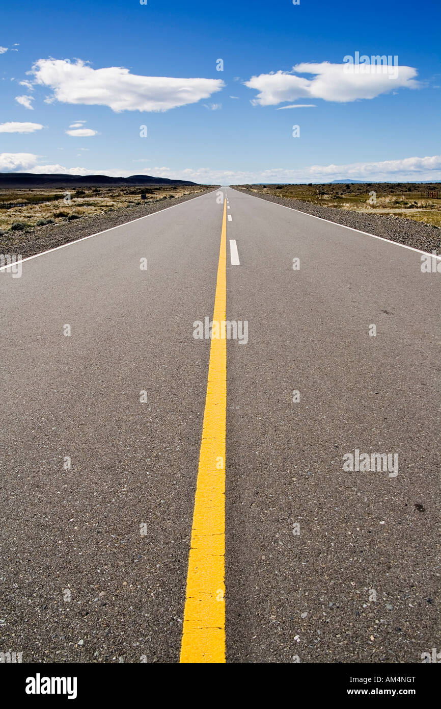 A long straight empty road stretching into the distance Two white ...