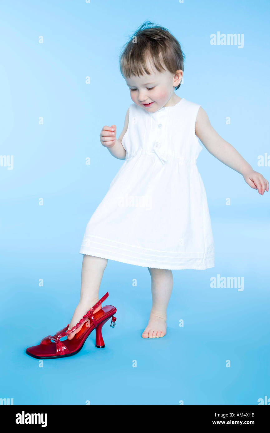 small girl trying on mother's shoes Stock Photo