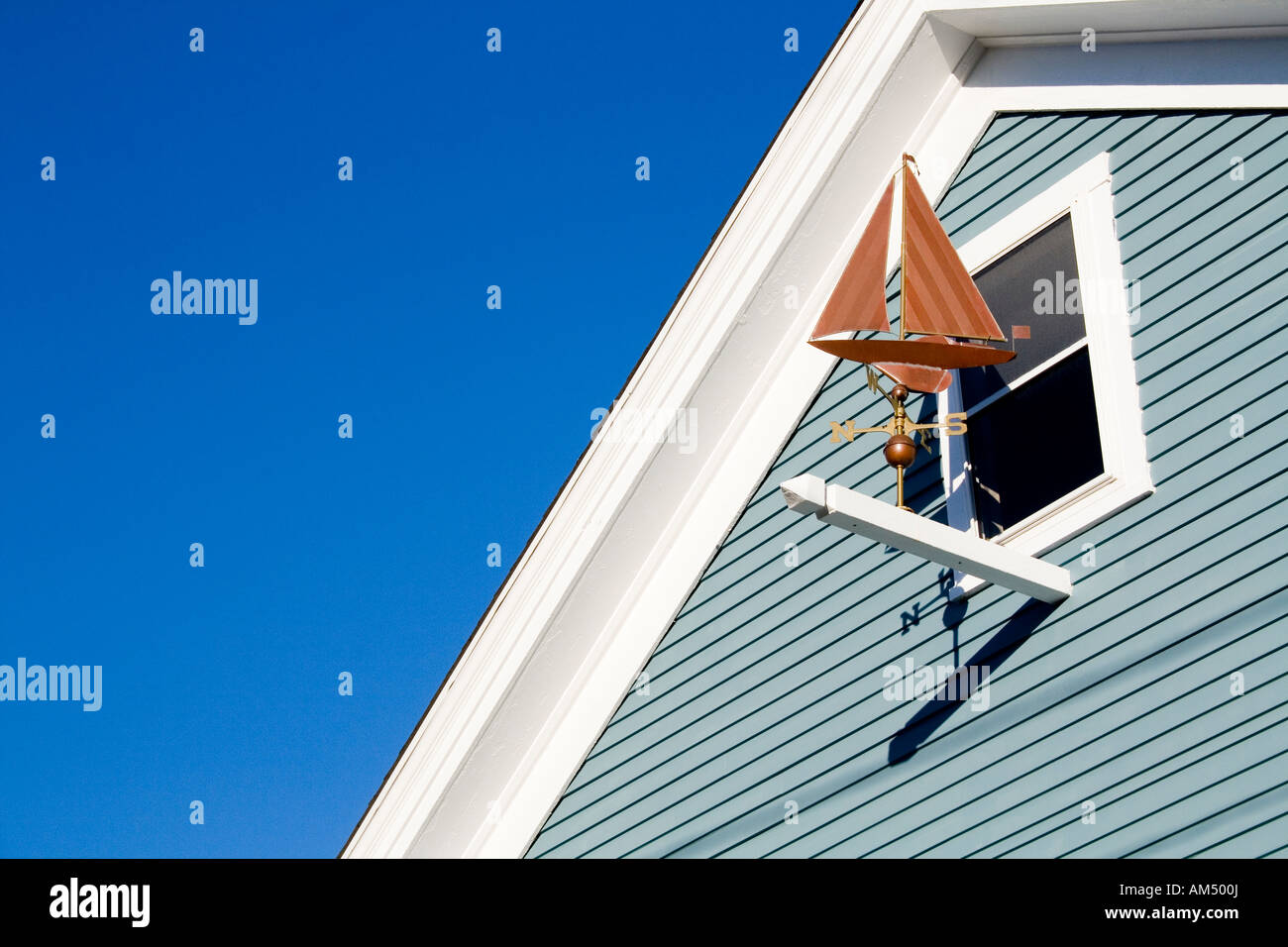 Sailboat weathervane by a window on Cape Cod Stock Photo Alamy