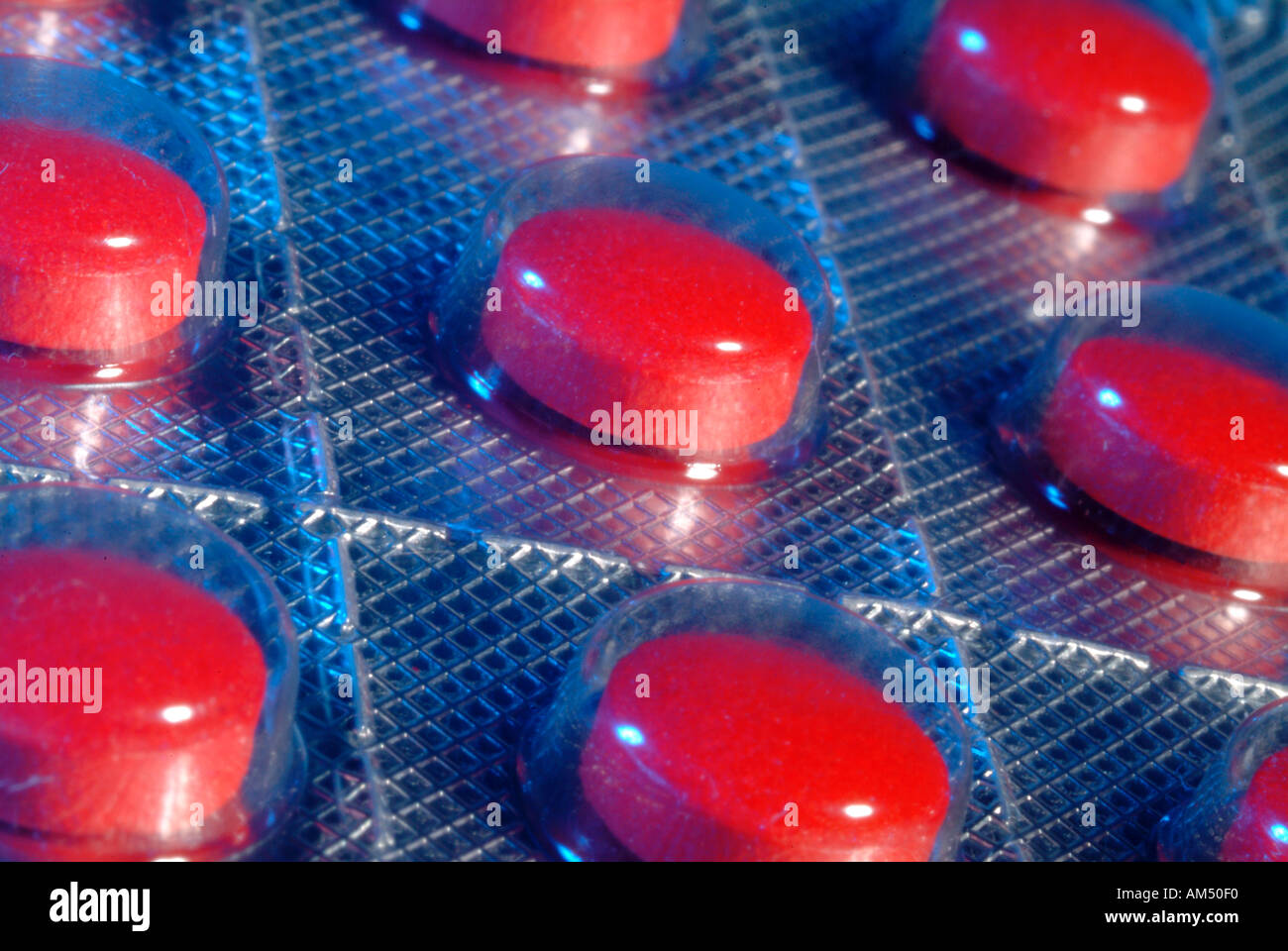 red medicine tablets in a foil blister package Stock Photo