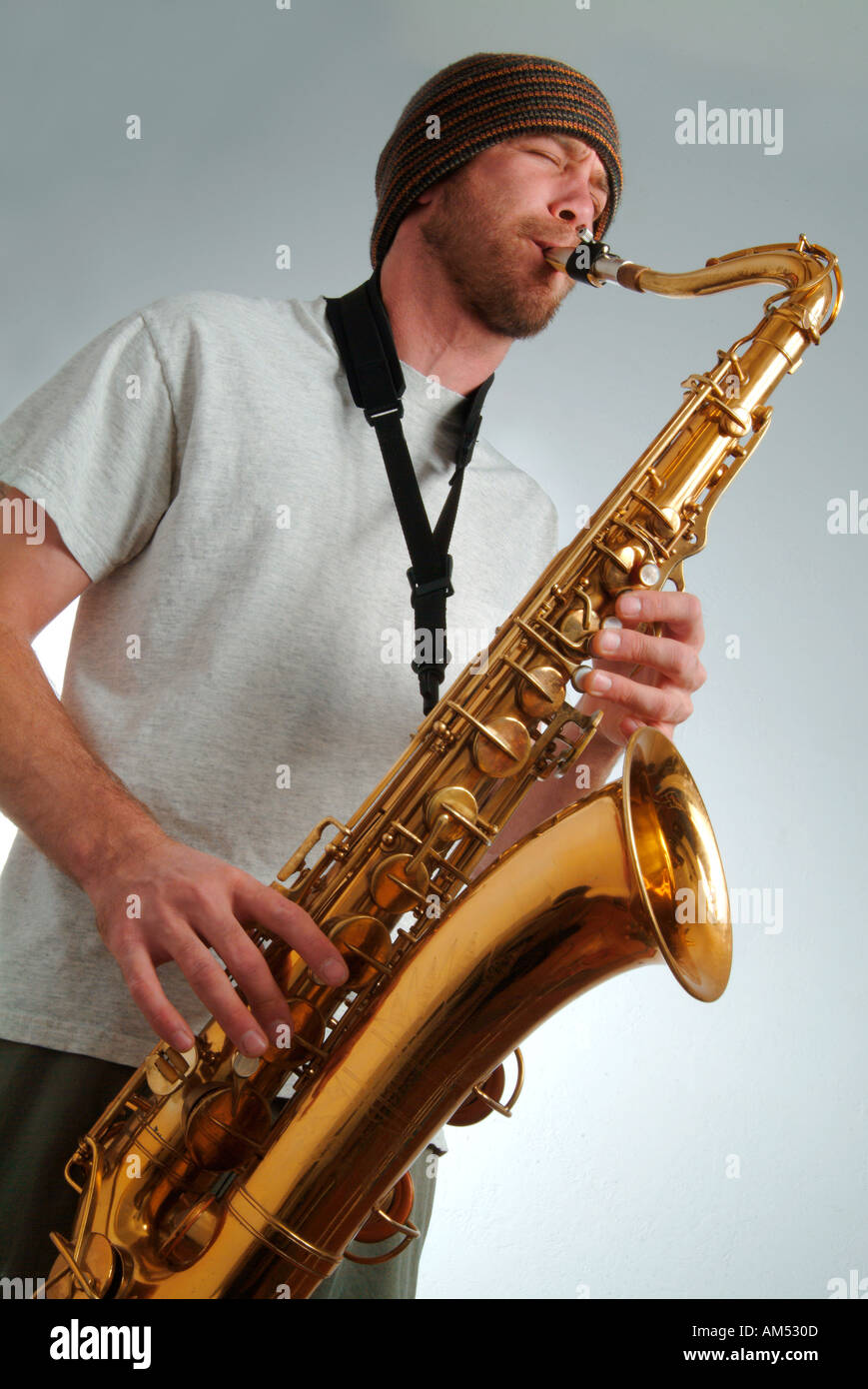 young musician playing a saxaphone Stock Photo