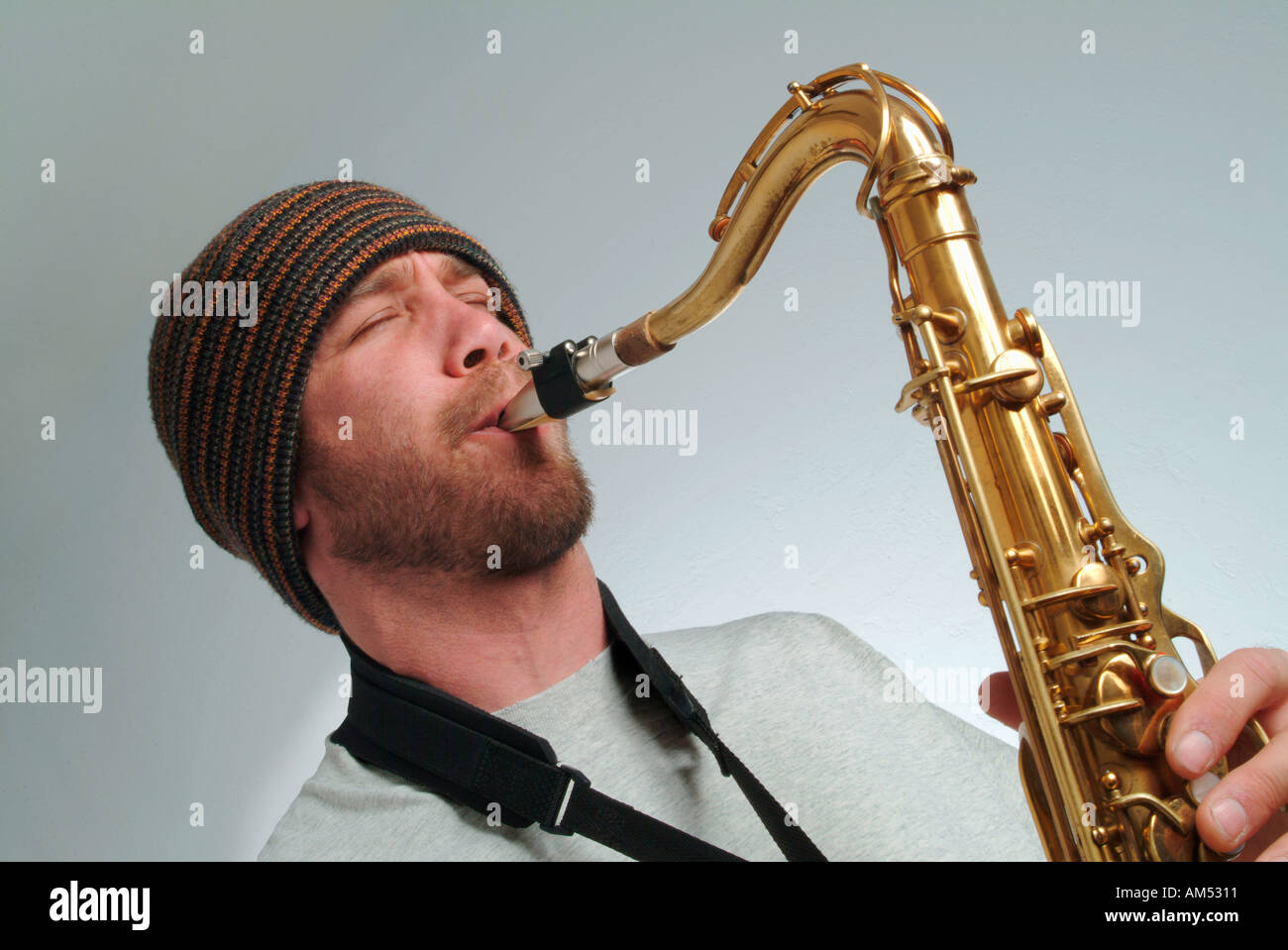 young musician playing a saxophone Stock Photo