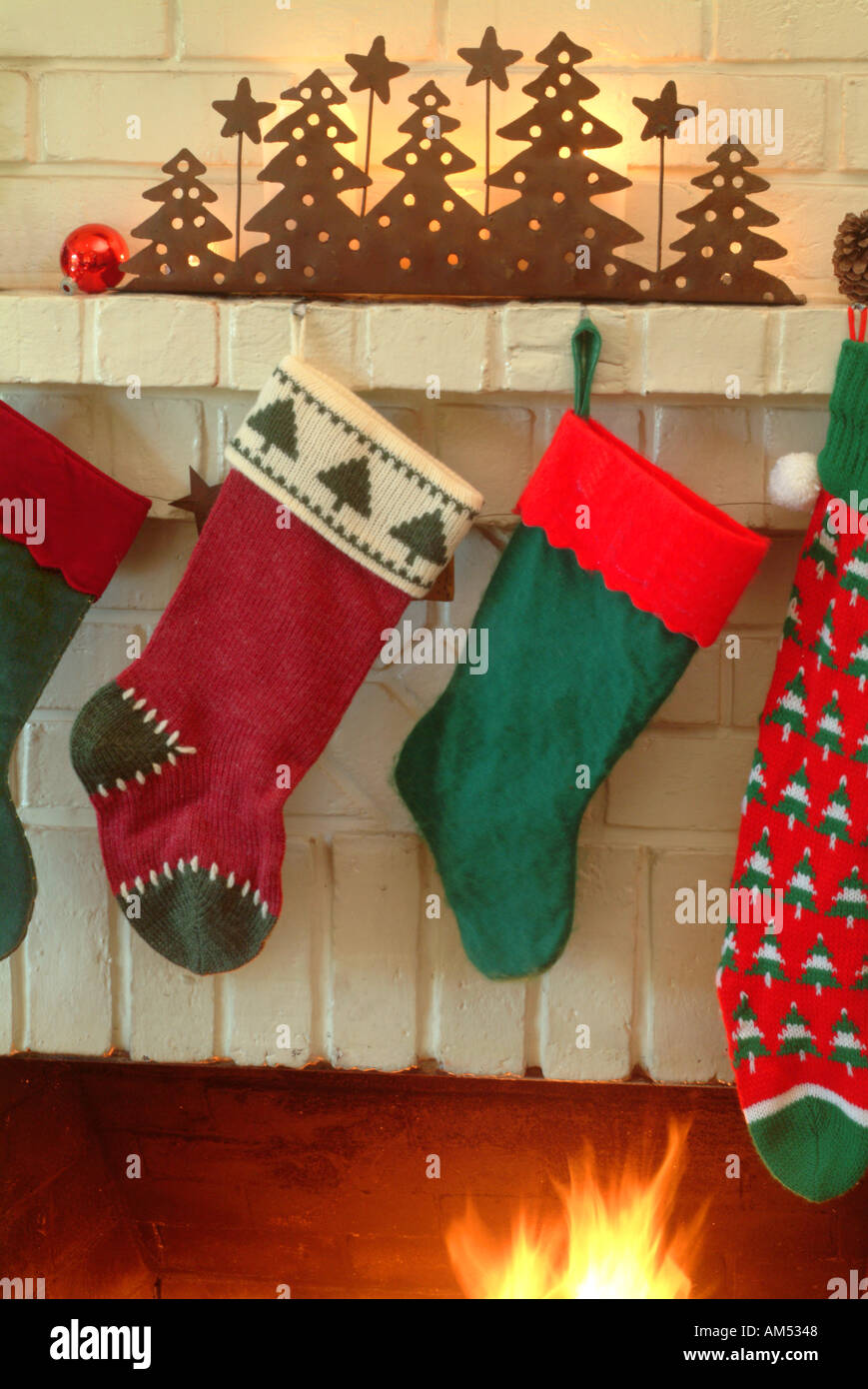 Christmas Stockings On The Mantle Above A Fireplace Stock Photo