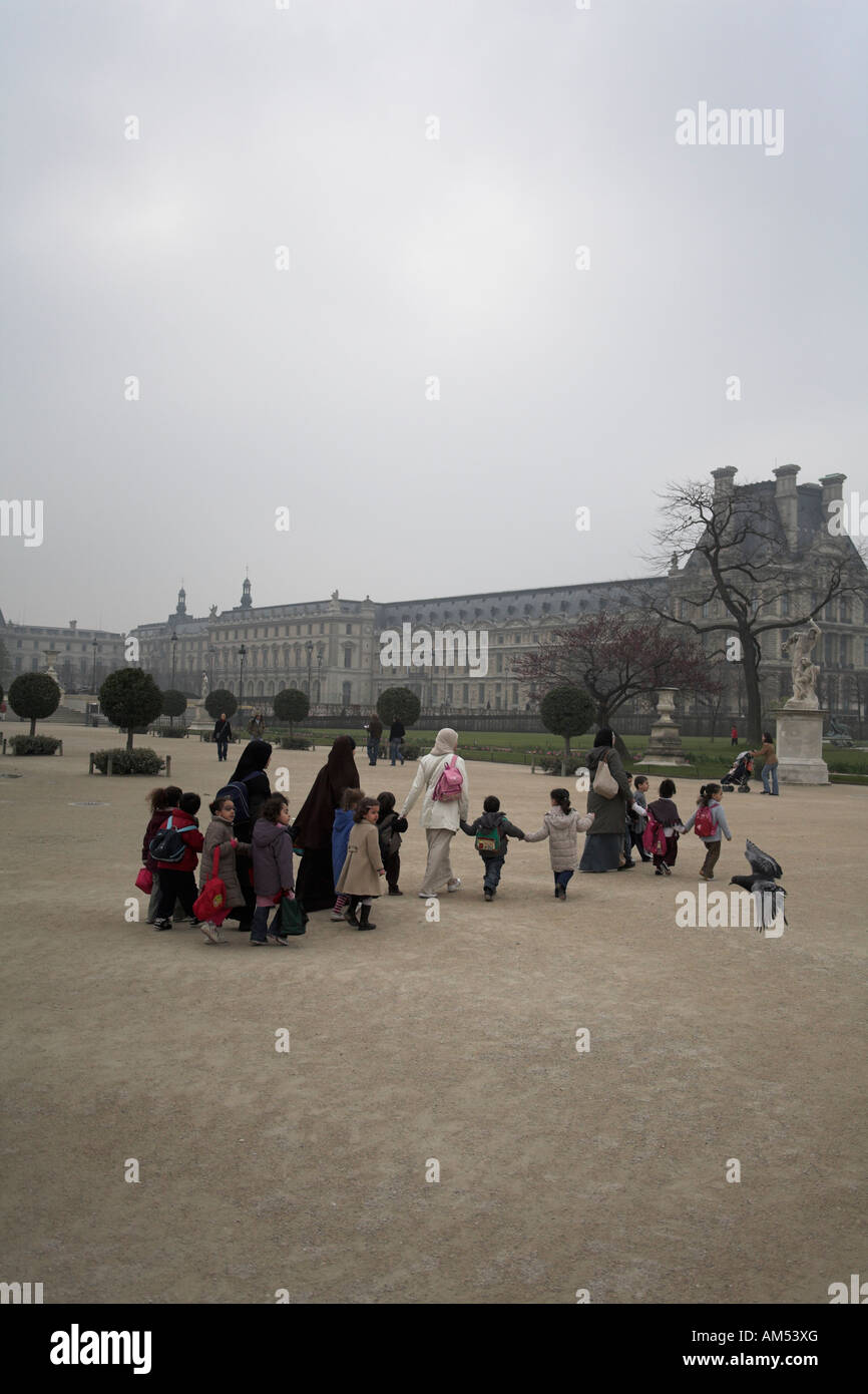 Young muslim women and children kindergarden or creche group at Tuileries garden paris france Stock Photo