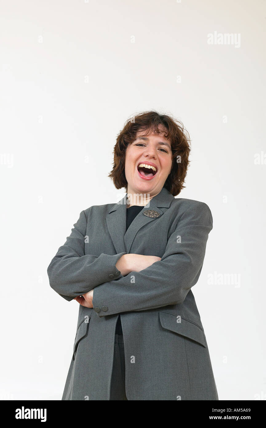 Business woman in gray suit laughing Stock Photo