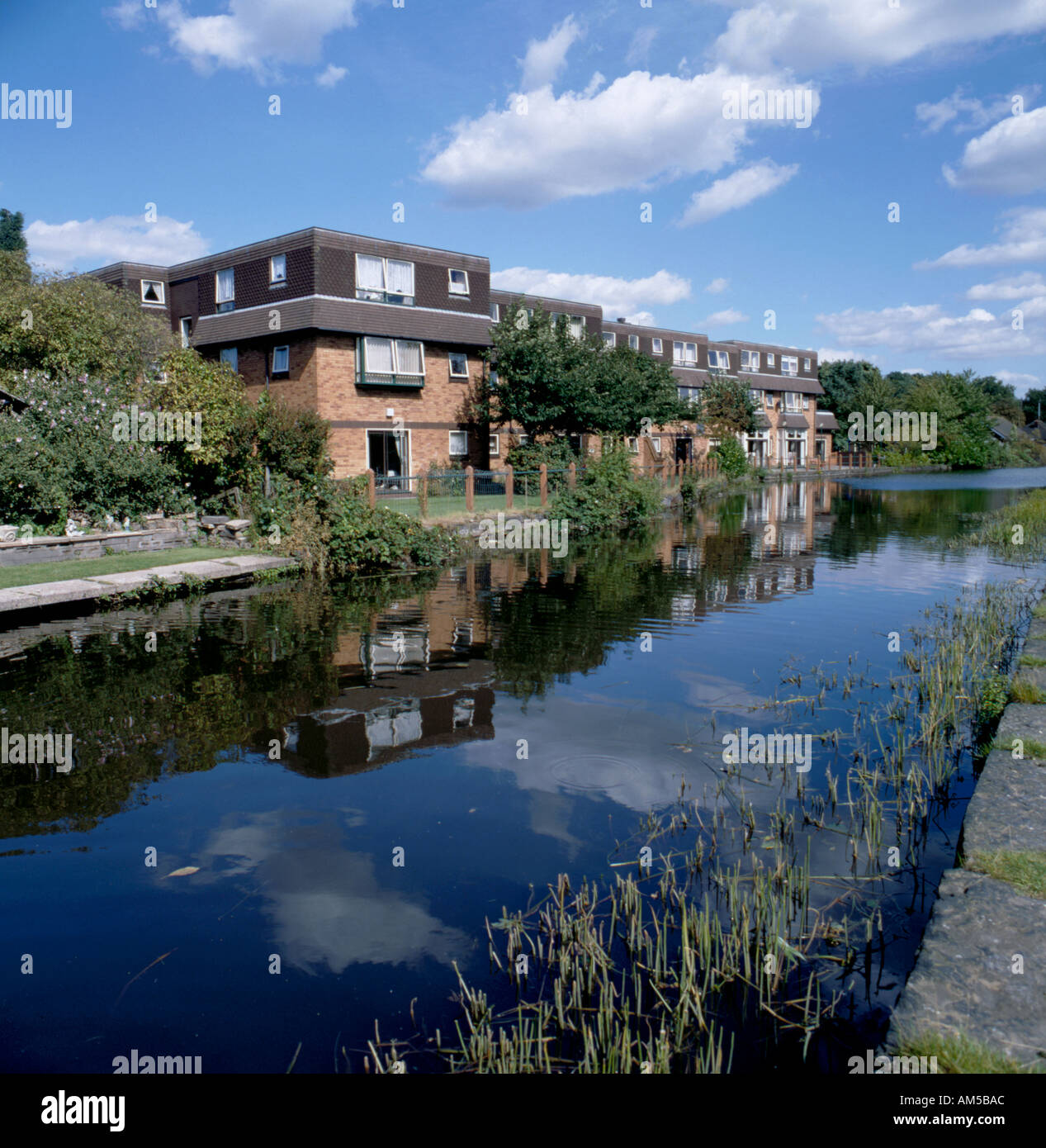 Stanmore House, a sheltered housing block seen, over the Ashton under Lyne Canal, Audenshaw, Tameside, Greater Manchester, England, UK. Stock Photo