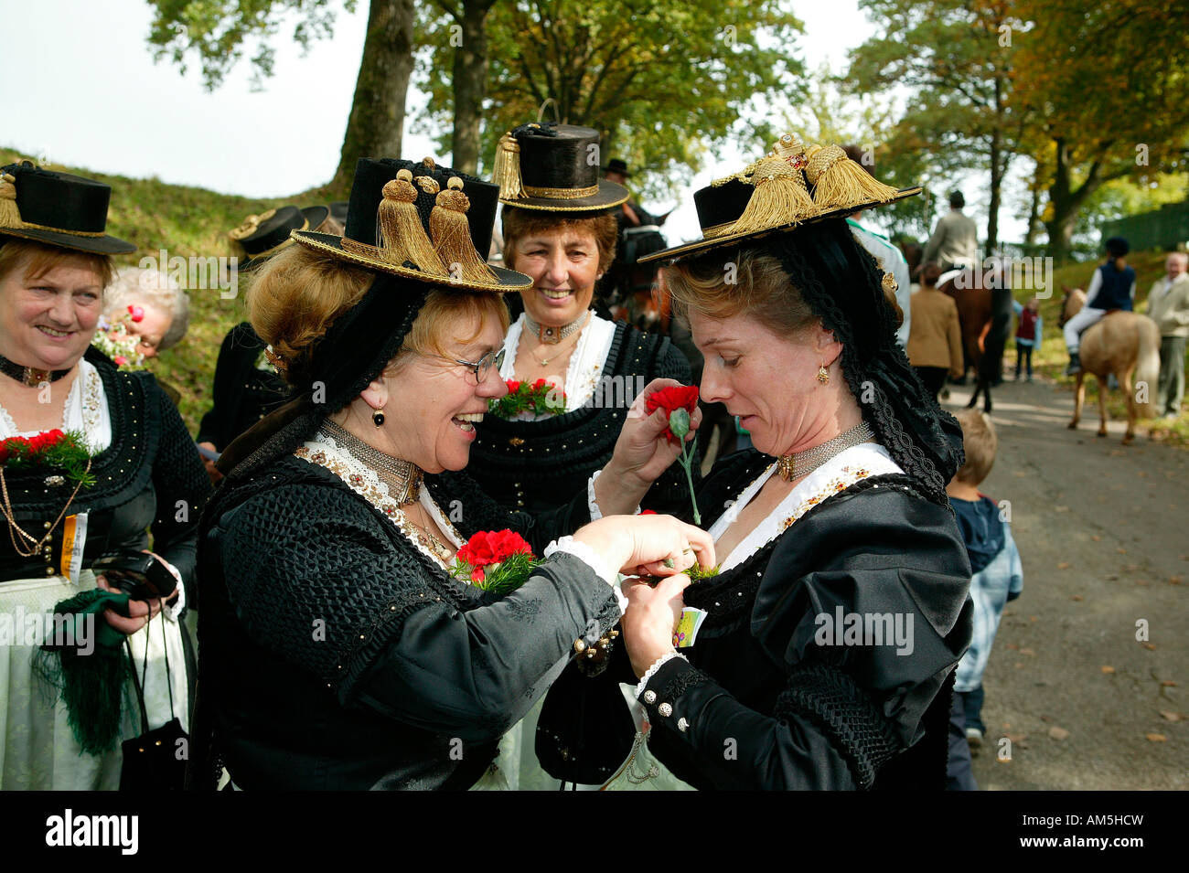 Women adorning themselves for the Leonhardifahrt in Thambach, Upper Bavaria, Bavaria, Germany Stock Photo