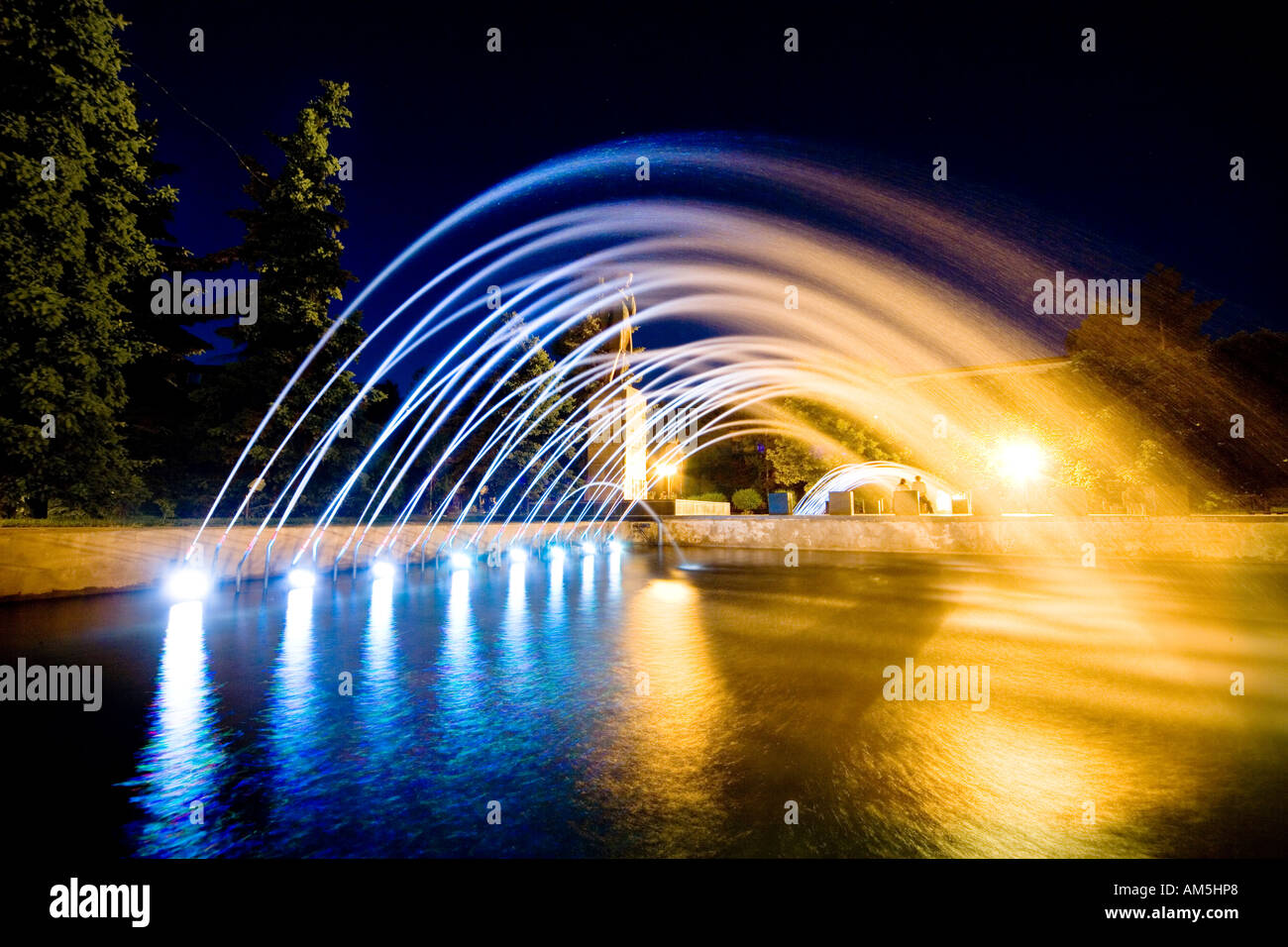 Colorful illuminated fountain of the monument to Chokan Valikhanov in central Almaty, Kazakhstan by night. Stock Photo
