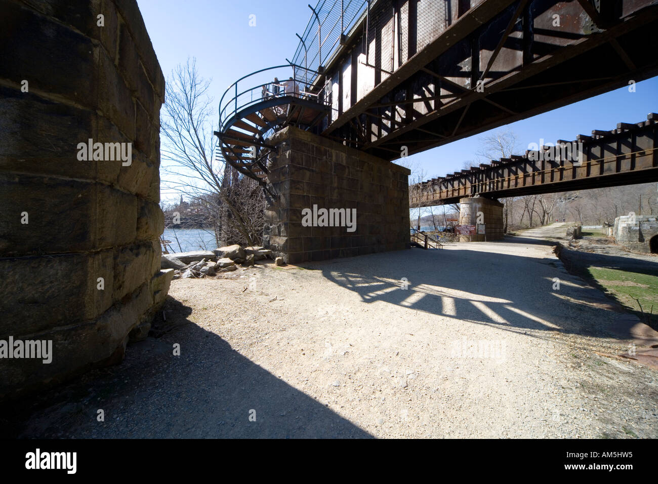 Railroad bridge crossing the Potomac river at Harper's Ferry seen from the Maryland side. Historic C and O Canal is on the right Stock Photo