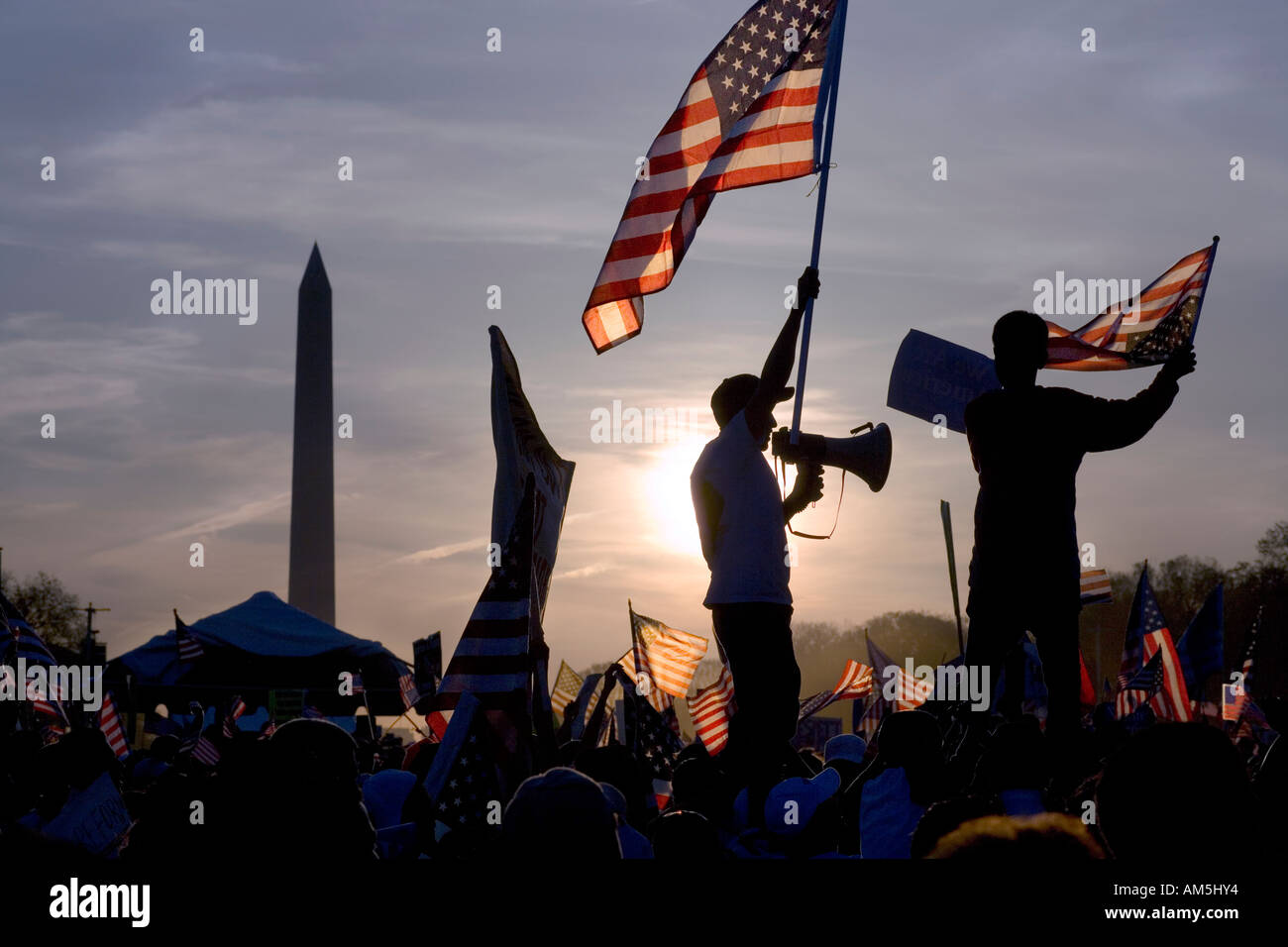 Immigrant waving flag holding a bullhorn at peaceful march of illegal immigrants in Washington DC protesting immigration law Stock Photo