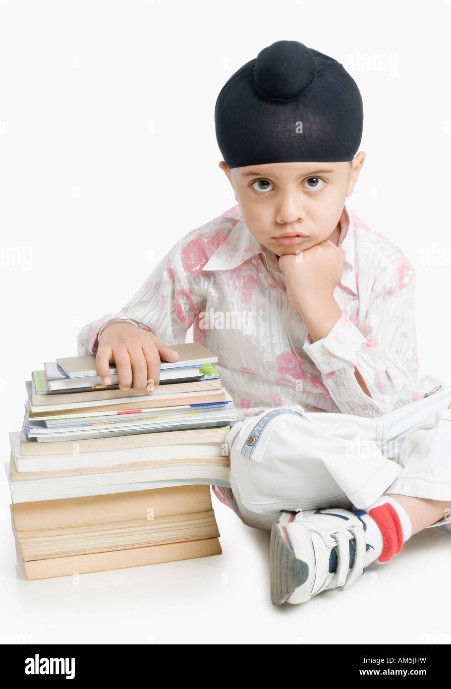 Portrait of a boy sitting with books Stock Photo - Alamy