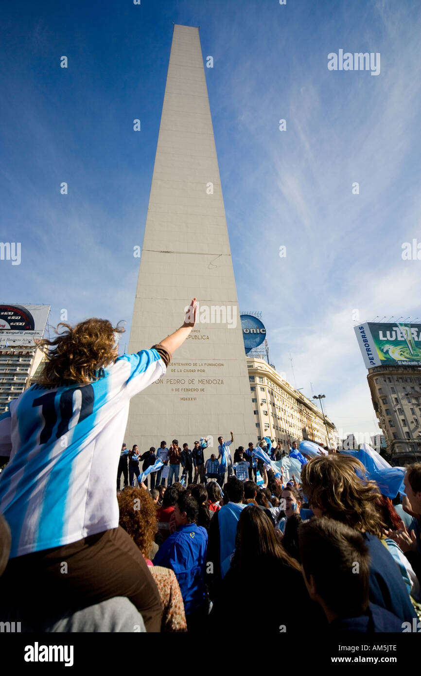 Soccer fans sing and wave Argentinian flags underneath the Obelisk in Buenos Aires. Stock Photo