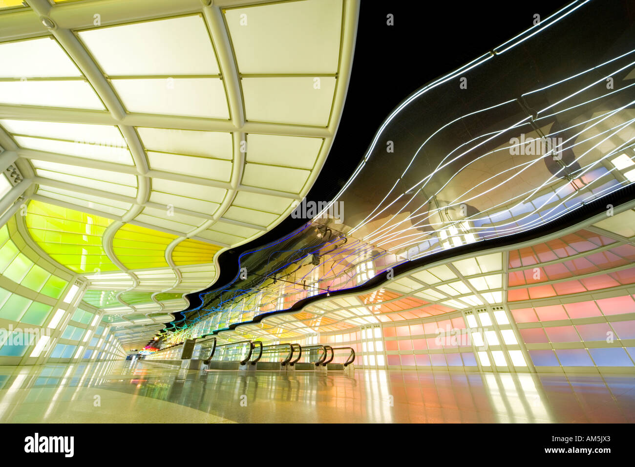 Extreme wide angle image of empty moving sidewalk in the tunnel at Chicago O'Hare airport with moving neon light pattern Stock Photo