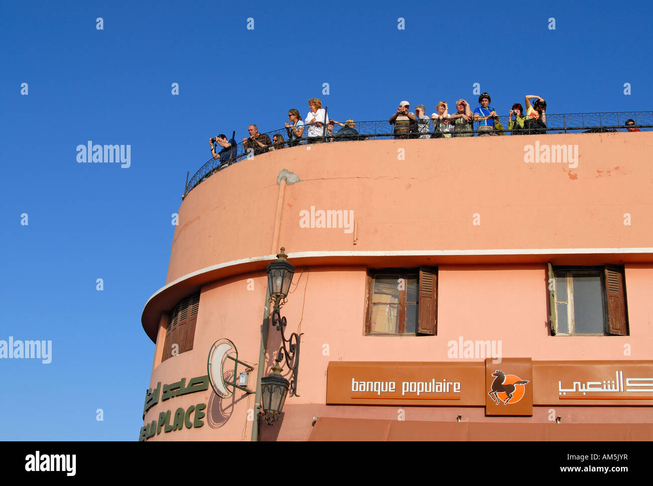 Foreign Tourists Viewing the Djemma el Fna Square (Place Jemmaa el Fna) in Marrakech (Marrakesh) From a Rooftop Terrace, Morocco Stock Photo
