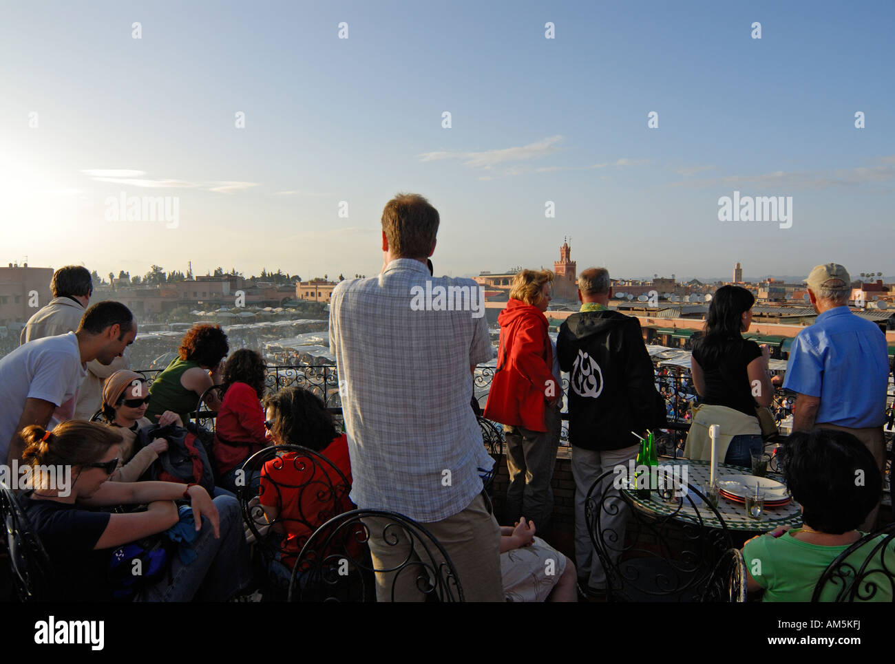 Foreign Tourists Photographing the Djemma el Fna Square (Place Jemmaa el Fna) in Marrakech (Marrakesh) From a Rooftop Terrace Stock Photo