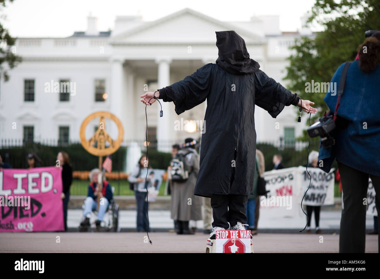 Iraq war protest. Masked protester in front of the White House Washington DC posing as a hooded prisoner from Abu Ghraib prison. Stock Photo