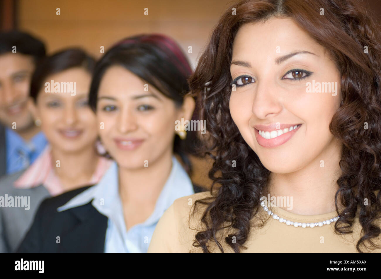 Four business executives standing in a row Stock Photo - Alamy