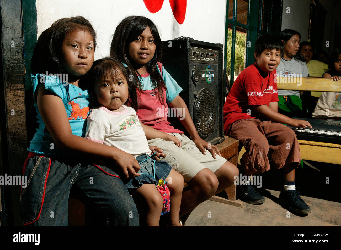 Indian children sitting next to an amplifier, Loma Plata, Chaco, Paraguay, South America Stock Photo
