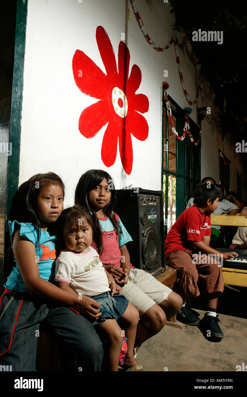 Indian children sitting next to an amplifier, Loma Plata, Chaco, Paraguay, South America Stock Photo