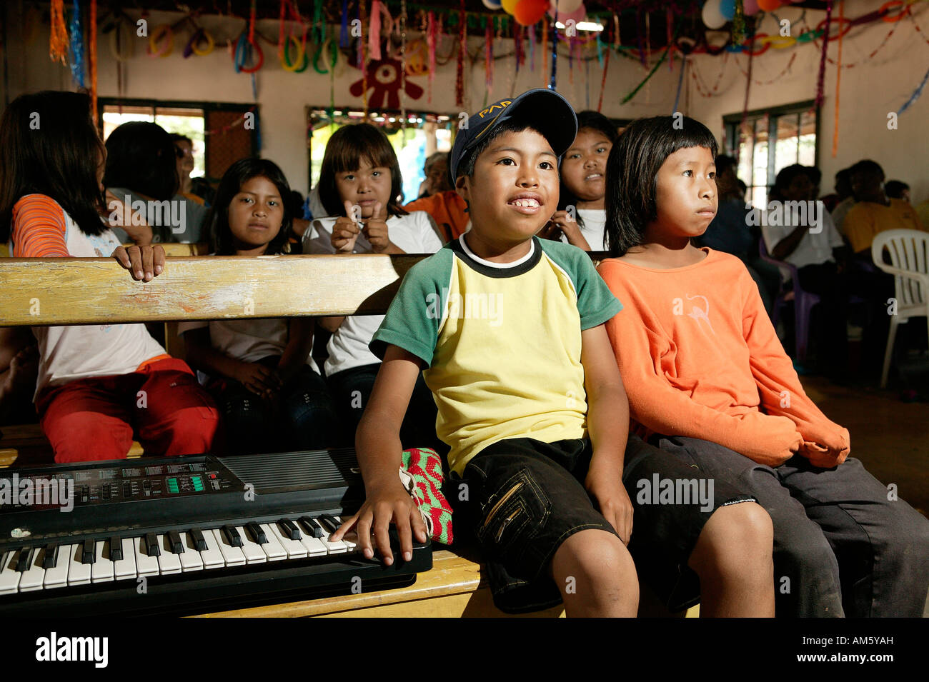 Indian children sitting next to an e-piano, Loma Plata, Chaco, Paraguay, South America Stock Photo