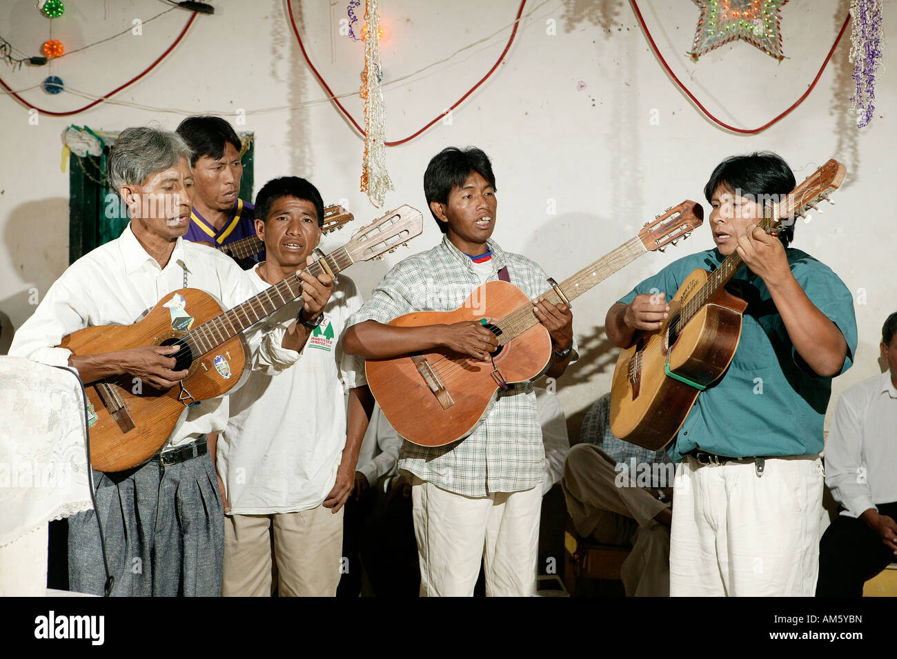 Indians playing guitar, Loma Plata, Chaco, Paraguay, South America Stock Photo