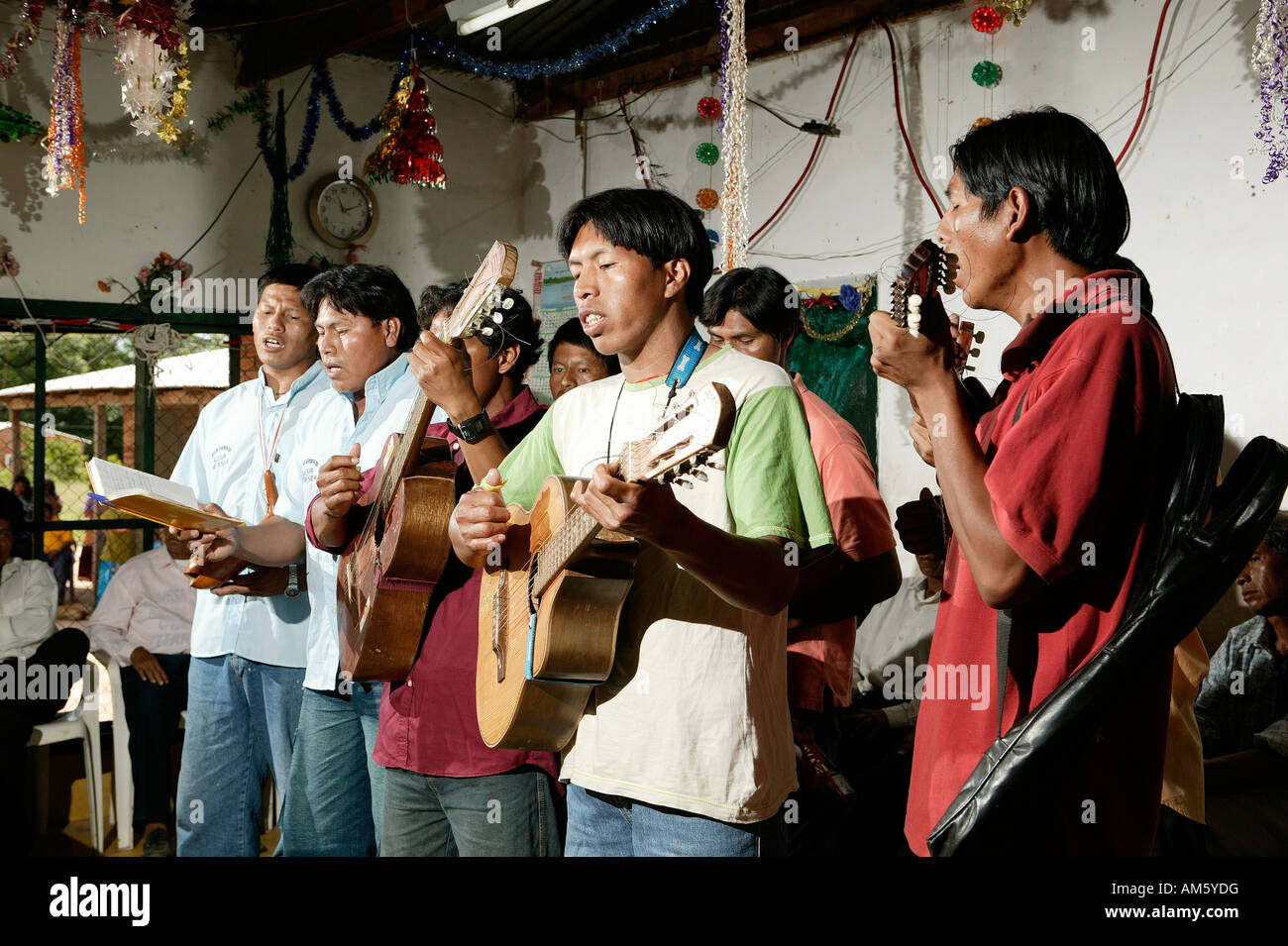 Indians playing guitar, Loma Plata, Chaco, Paraguay, South America Stock Photo