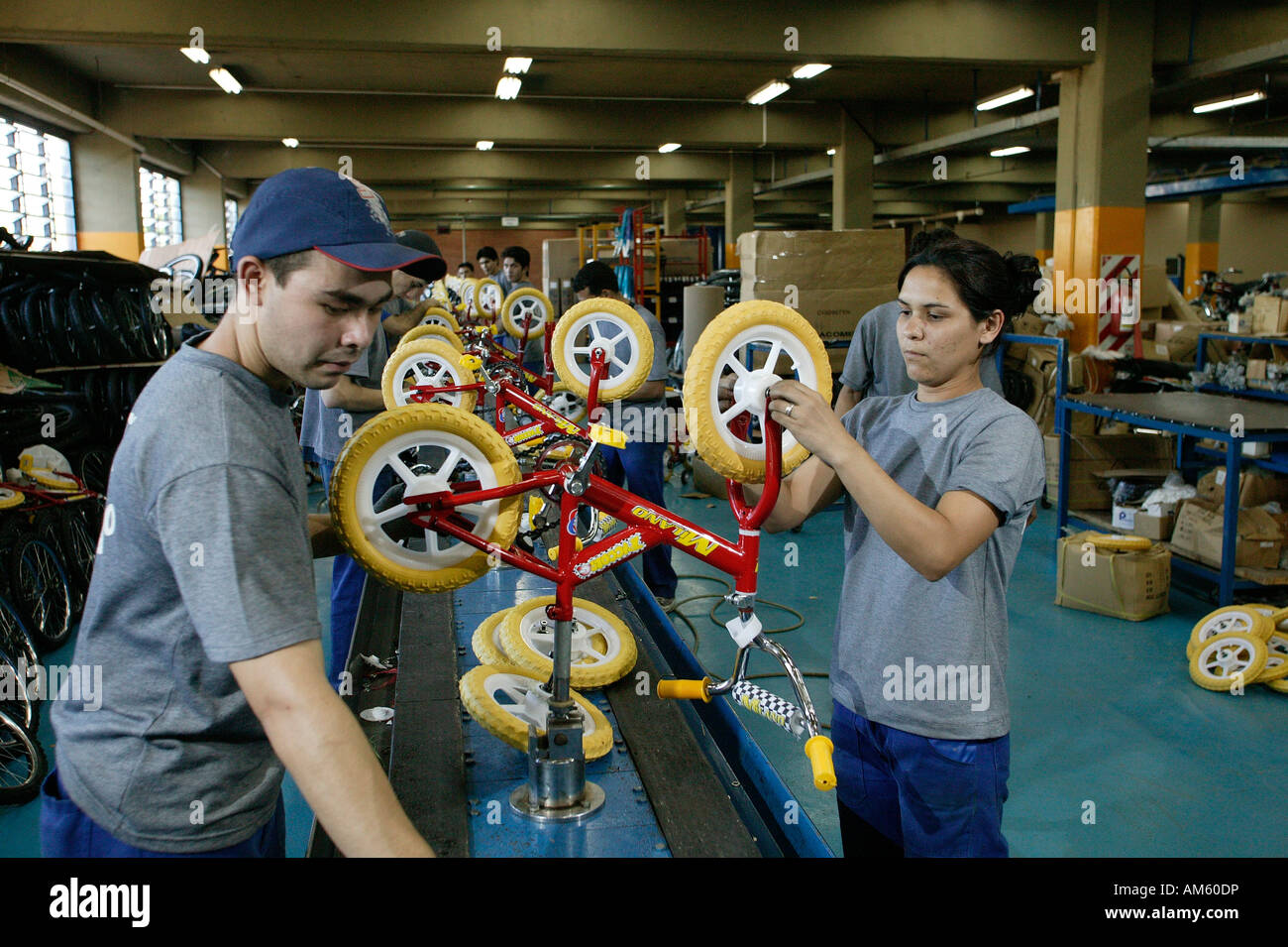 Woman testing children's bicycles in a factory, Asuncion, Paraguay, South America Stock Photo
