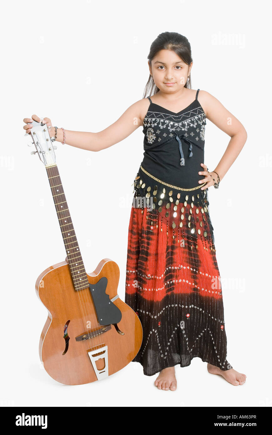 Portrait of a girl standing and holding a guitar Stock Photo - Alamy