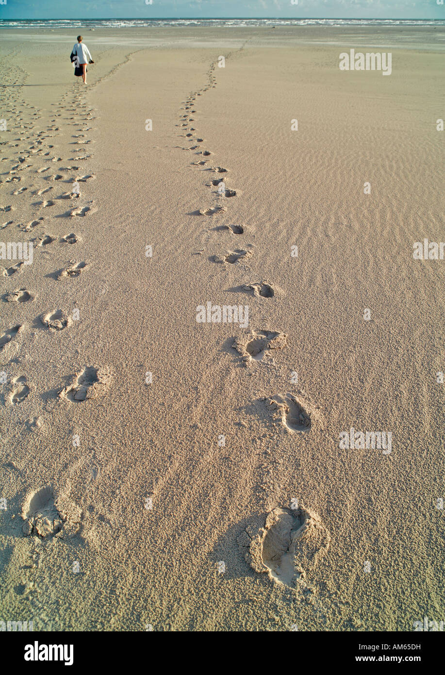 Foot prints in sand with walking person, Juist, Lower Saxony, Germany Stock Photo