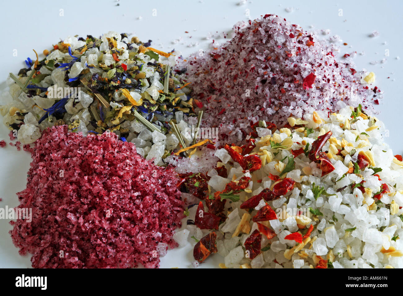 Colourful sea salts, with several spices and herbs like hibiscus, rose petals, chili and paprika