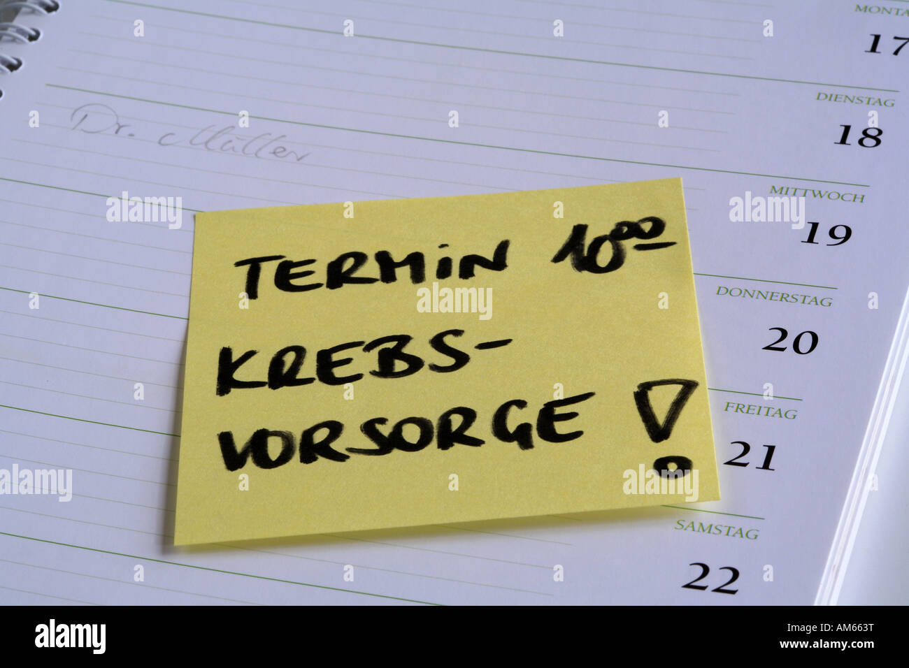 Yellow reminder note 'Termin' (cancer checkup appointment) on the page of a calendar Stock Photo