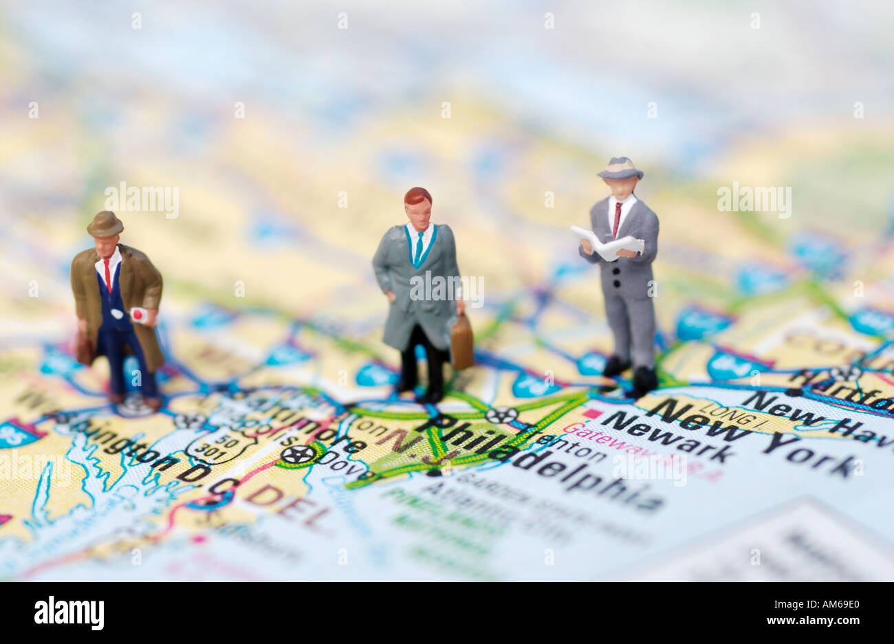 Three businessmen figures standing on map of East Coast Stock Photo