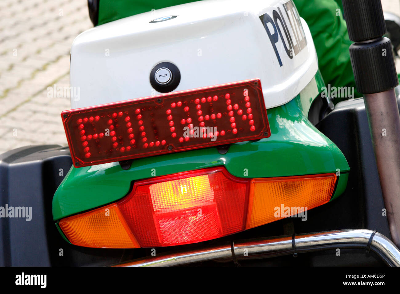 Police motorcycle with 'Folgen' (Follow) sign Stock Photo