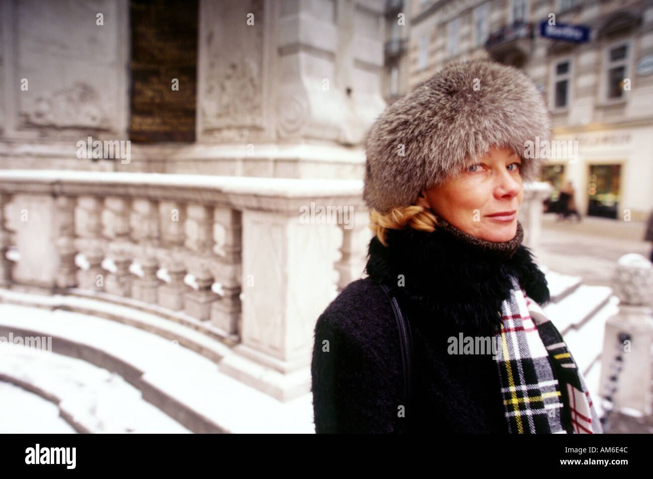 Russian Female teacher in her 30s 40s in grey fur hat black coat and scarf  with marble statue base and railing in background Stock Photo - Alamy